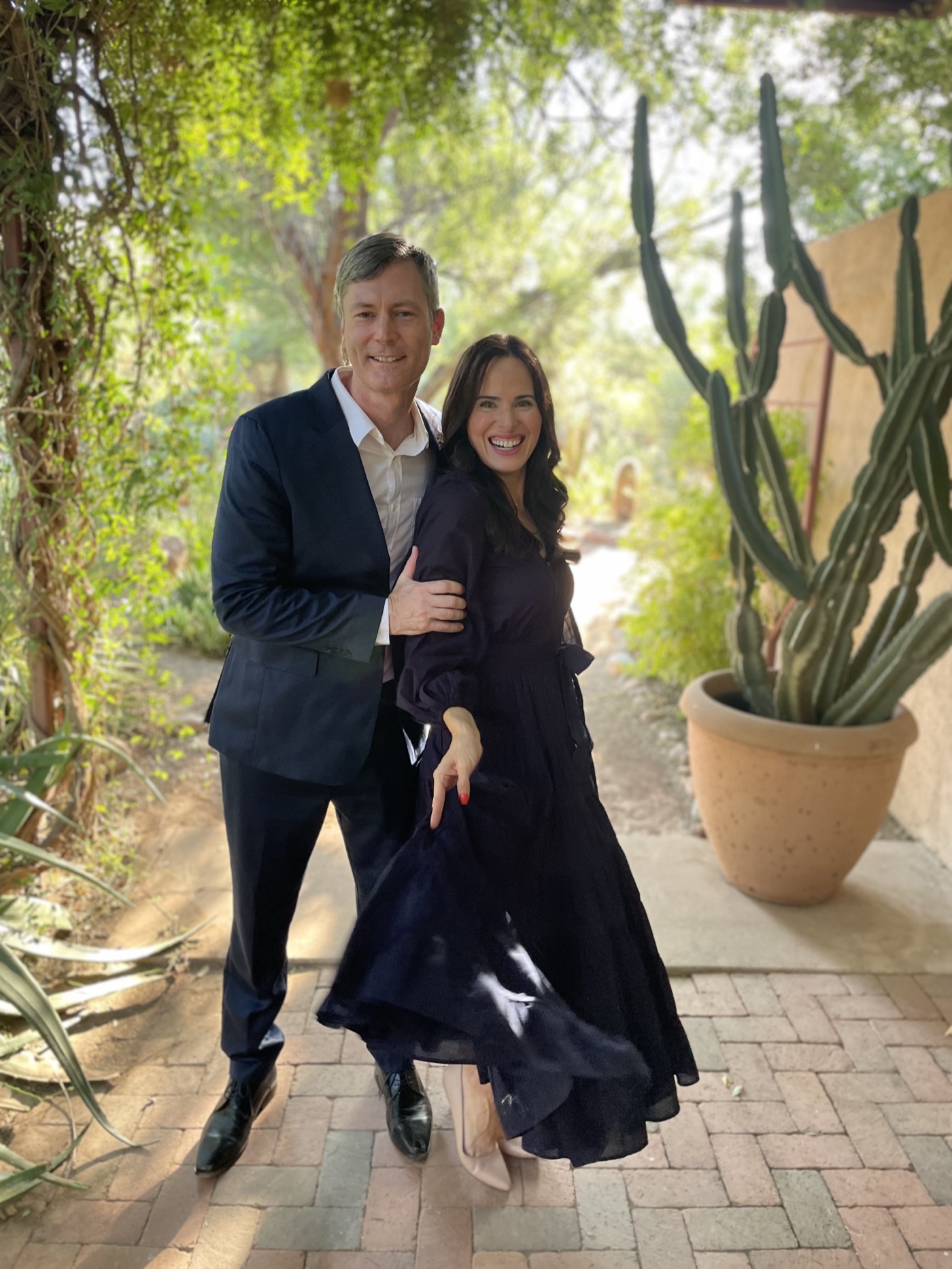 Derek and Amber smiling together in a desert garden